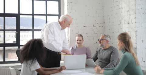 Group of people sitting around a table talking