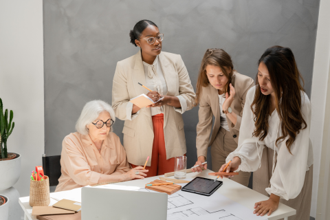 Four women working around a table